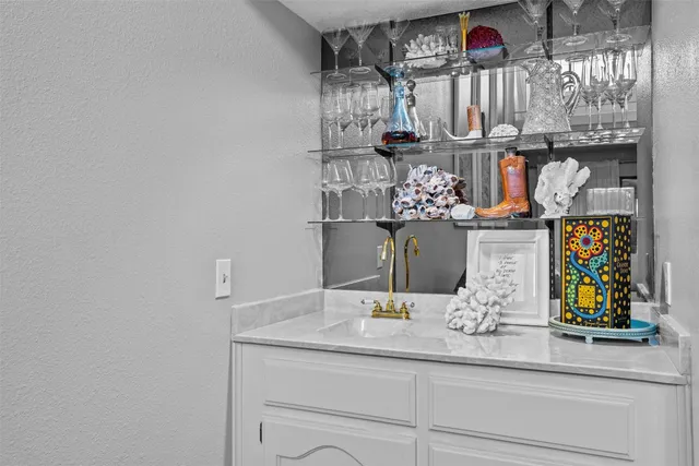 a kitchen with a sink and chandelier