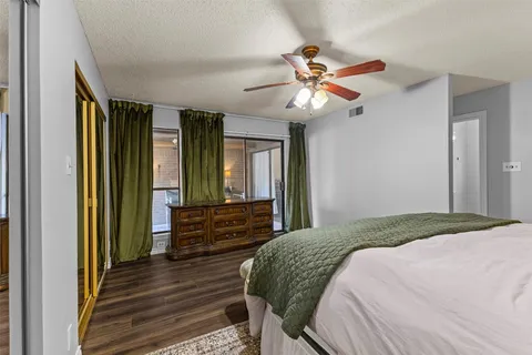 a bedroom with a bed chandelier and a window