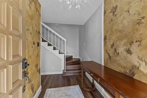 a view of entryway and hall with wooden floor