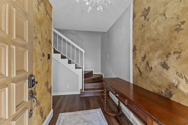 a view of entryway and hall with wooden floor