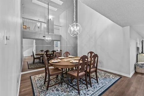 a view of a dining room with furniture and chandelier