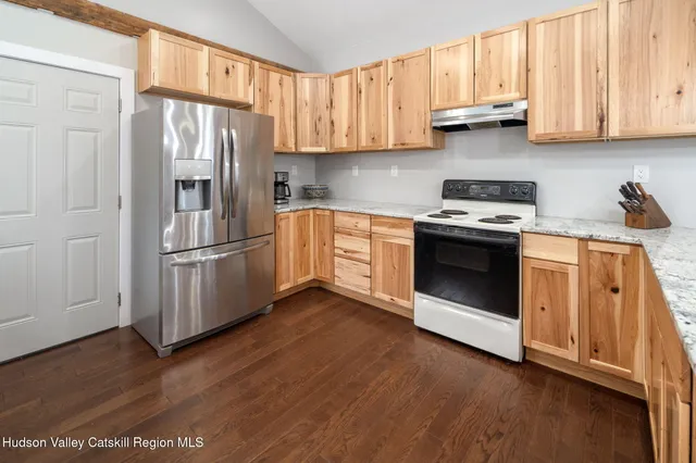 a kitchen with stainless steel appliances granite countertop a refrigerator sink and cabinets