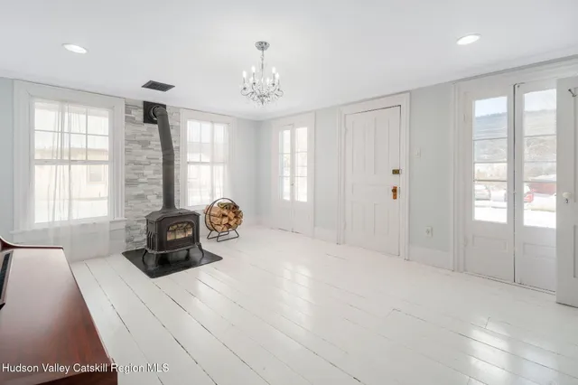 a spacious bedroom with a bed and a large window