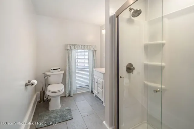 a bathroom with a toilet and a shower