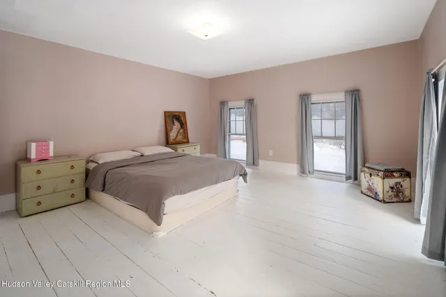 a spacious bedroom with a bed and a closet