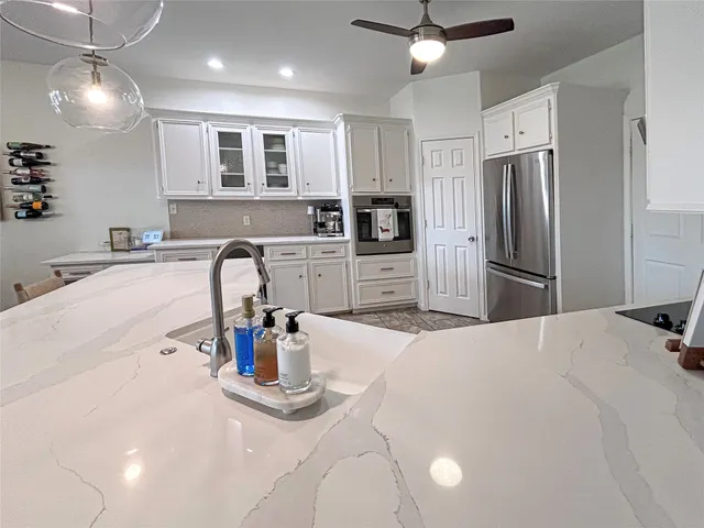 a kitchen with refrigerator a microwave and stove