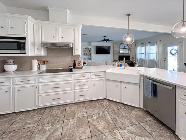 a kitchen with cabinets appliances and a sink