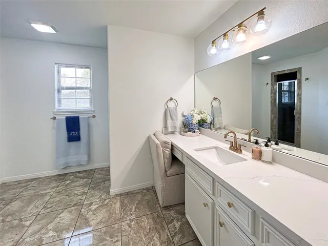 a bathroom with a sink a vanity and a mirror