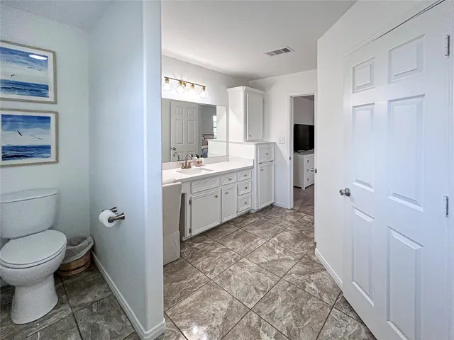 a bathroom with a toilet sink and a mirror