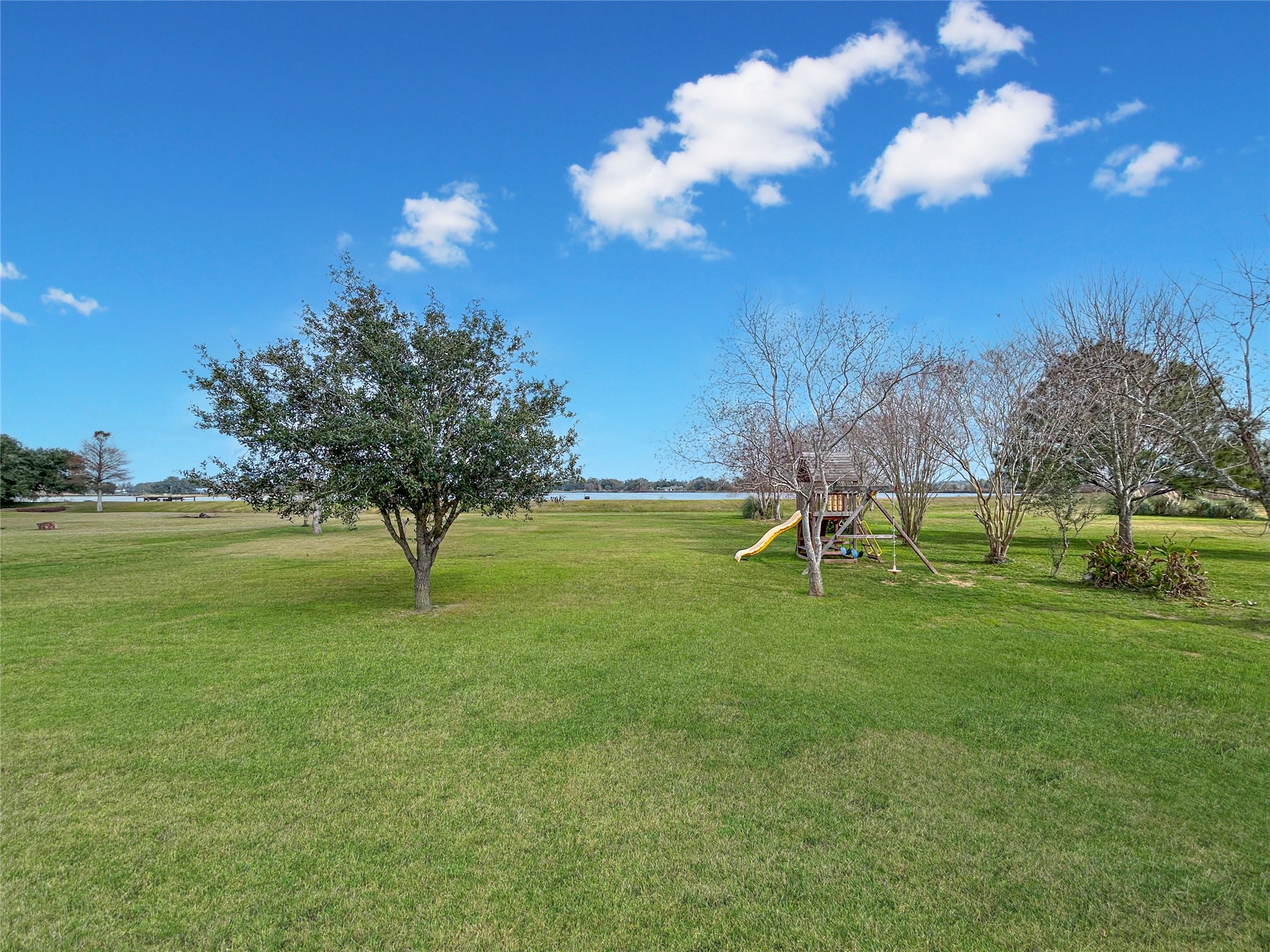 626 Sunset Trail Angleton, TX 77515 - Photo 40 of 43 a view of a golf course with a lake
