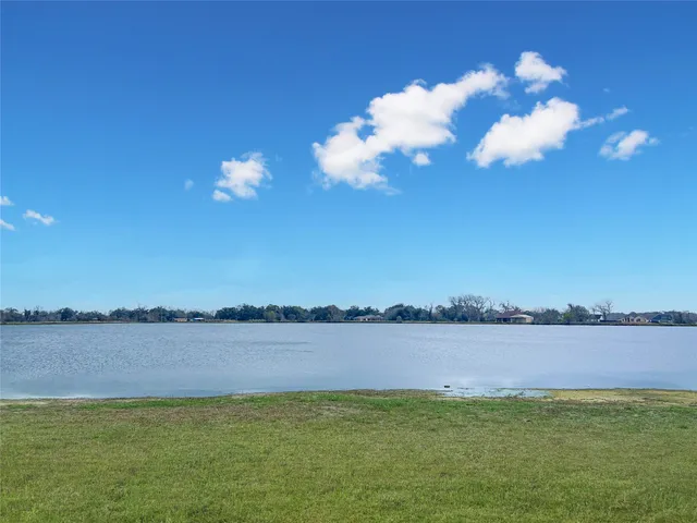 a view of a lake with houses in the background