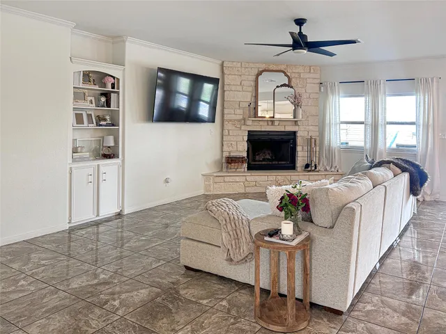 a living room with furniture a fireplace and a flat screen tv