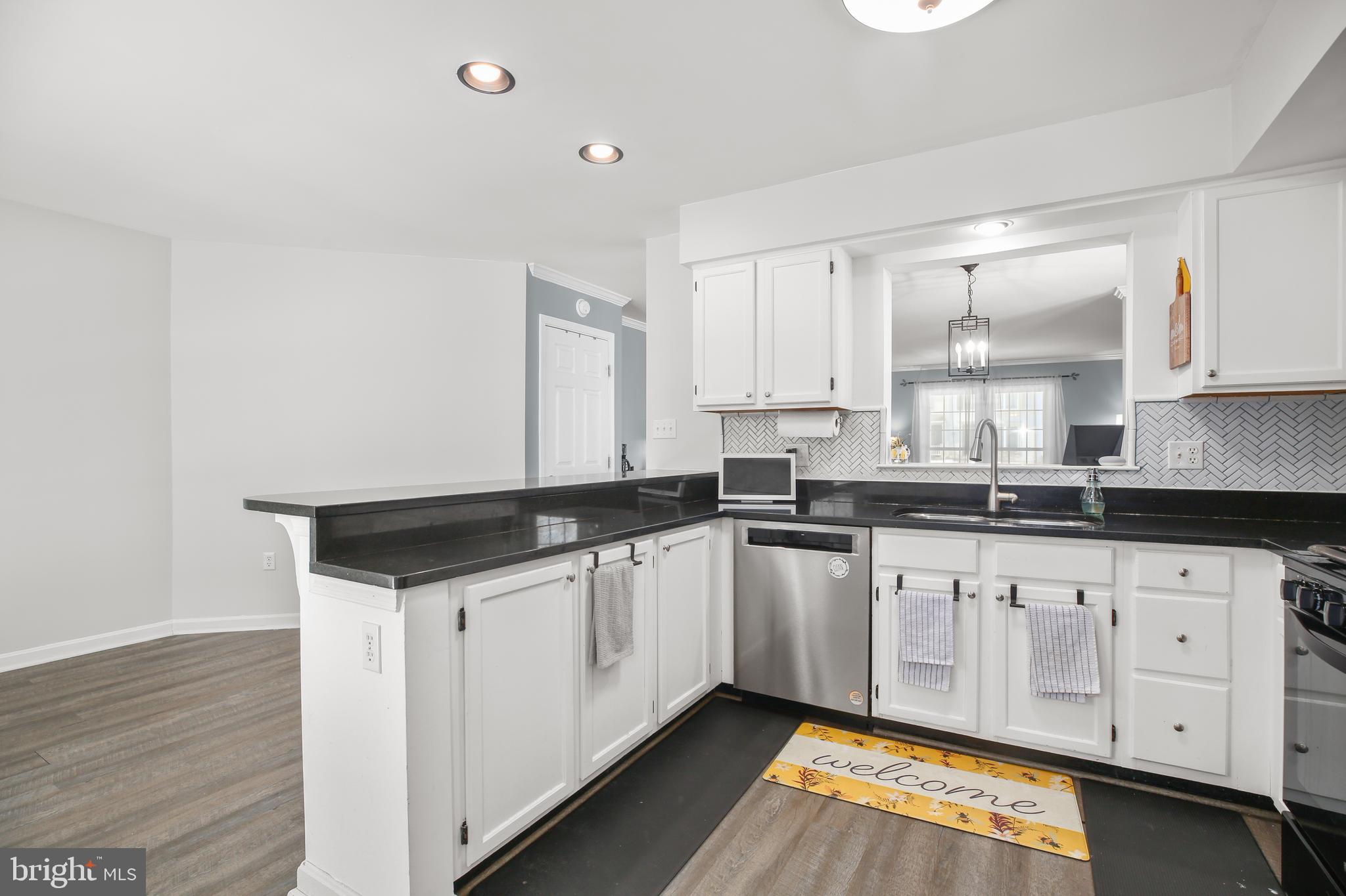 12385 Manchester Way Woodbridge, VA 22192 - Photo 10 of 32 a kitchen with granite countertop white cabinets and a sink