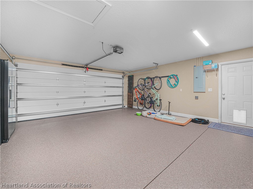 5430 Lakewood Road Sebring, FL 33875 - Photo 23 of 40 Attached 2-car Garage w/Epoxy painted floor, new instant hot -tankless hot water heater & 50 AMP generator ready inlet/transfer switch