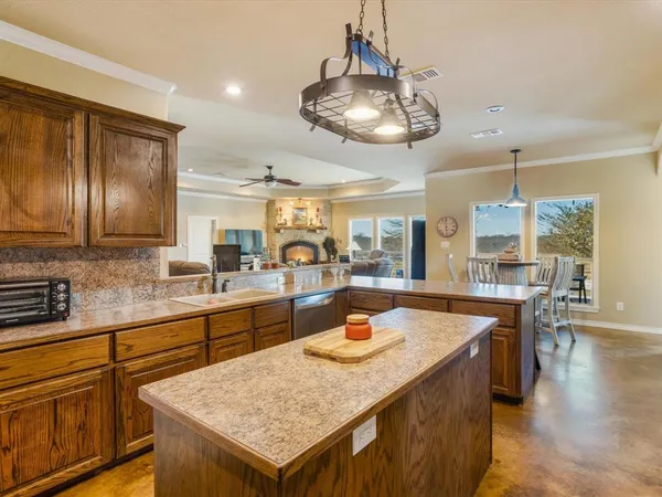 a large kitchen with a table and chairs