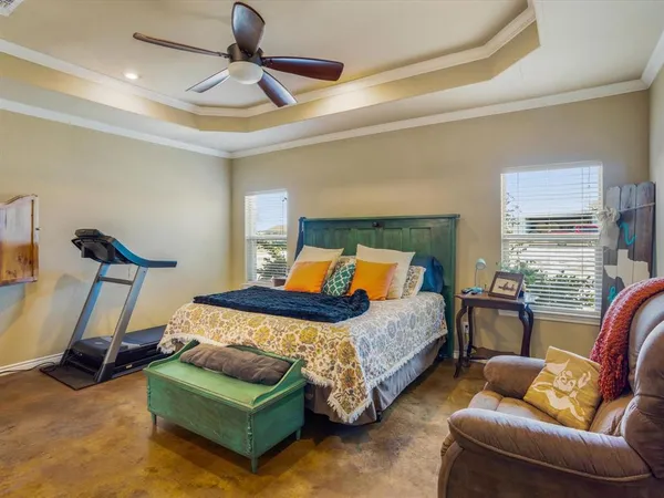 a bedroom with bed couch and window