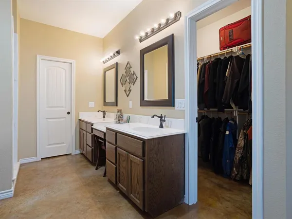 a bathroom with a sink vanity and a mirror