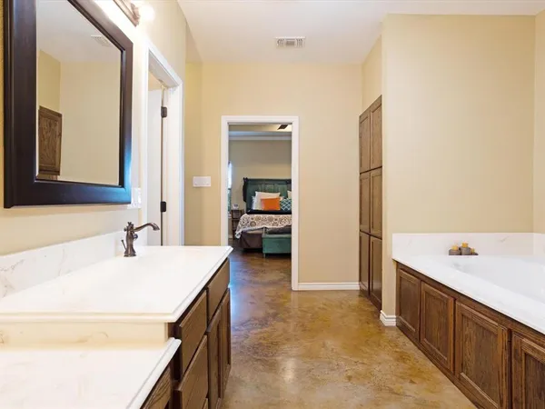 a en suite bathroom with a sink and a large mirror
