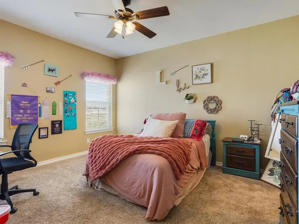 a bedroom with a bed dresser and a window