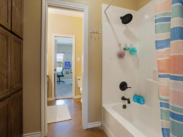 a bathroom with a tub and shower