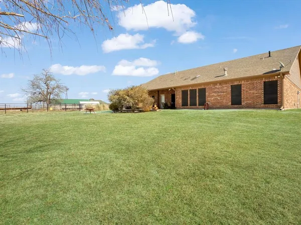 a big yard with large trees