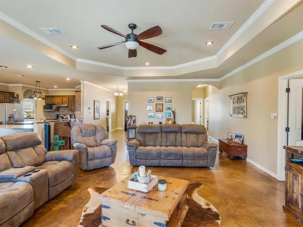 a living room with furniture and a view of kitchen