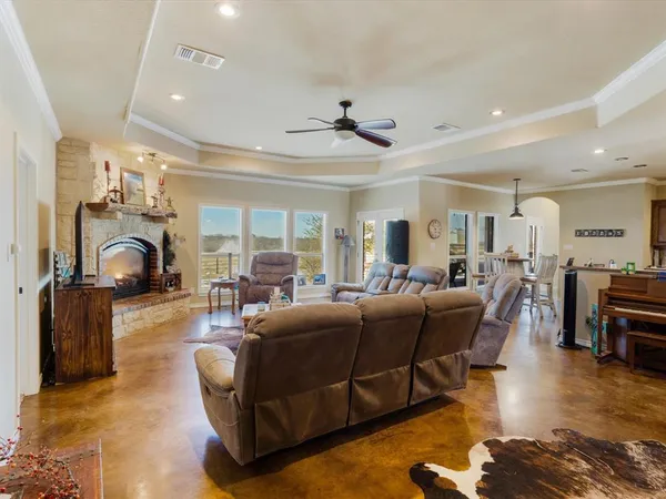 a living room with furniture a table and wooden floor