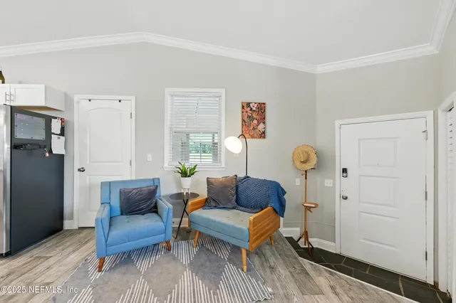 a living room with furniture a clock and a window