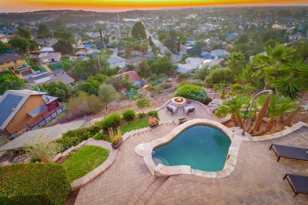7970 Pasadena Avenue La Mesa, CA 91941 - Photo 15 of 38 an aerial view of a house with a swimming pool yard and mountain view in back