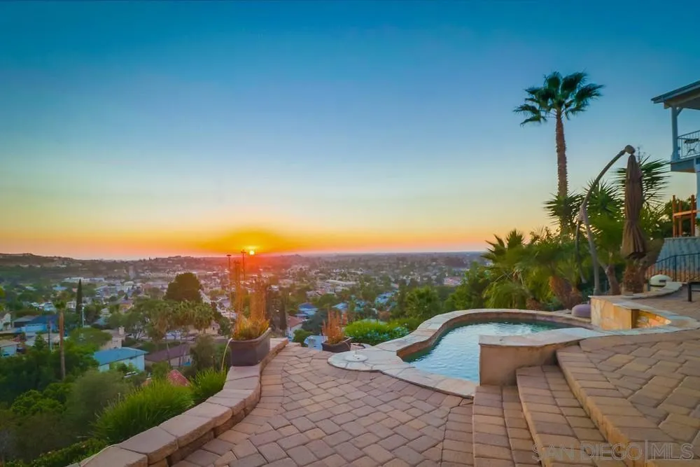 7970 Pasadena Avenue La Mesa, CA 91941 - Photo 16 of 38 a view of a swimming pool with a lounge chair and a small yard