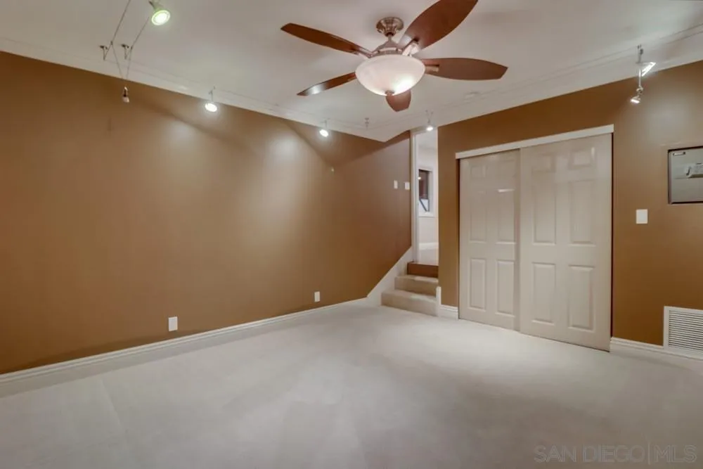 7970 Pasadena Avenue La Mesa, CA 91941 - Photo 27 of 38 an empty room with closet and a chandelier fan