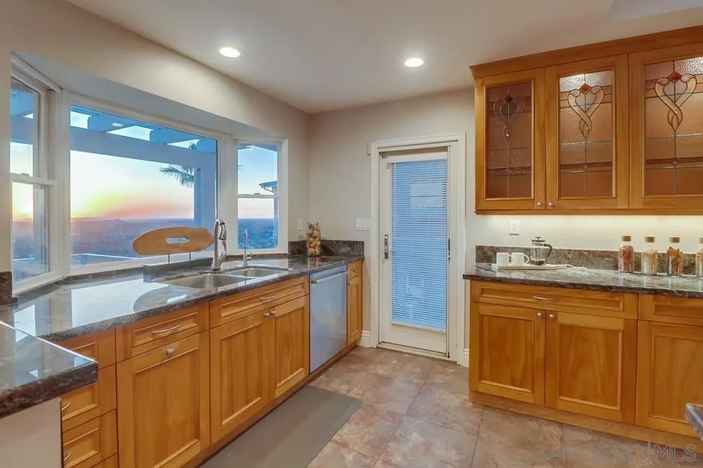 7970 Pasadena Avenue La Mesa, CA 91941 - Photo 8 of 38 a bathroom with a granite countertop sink mirror and double