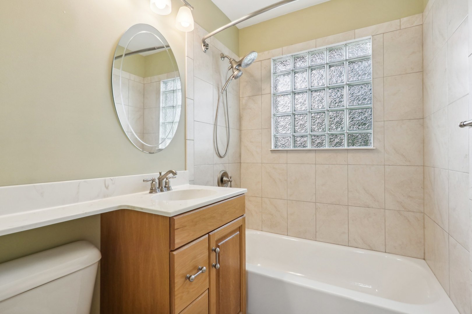 2405 Martin Lane Rolling Meadows, IL 60008 - Photo 13 of 22 a bathroom with a sink vanity tub shower and a mirror