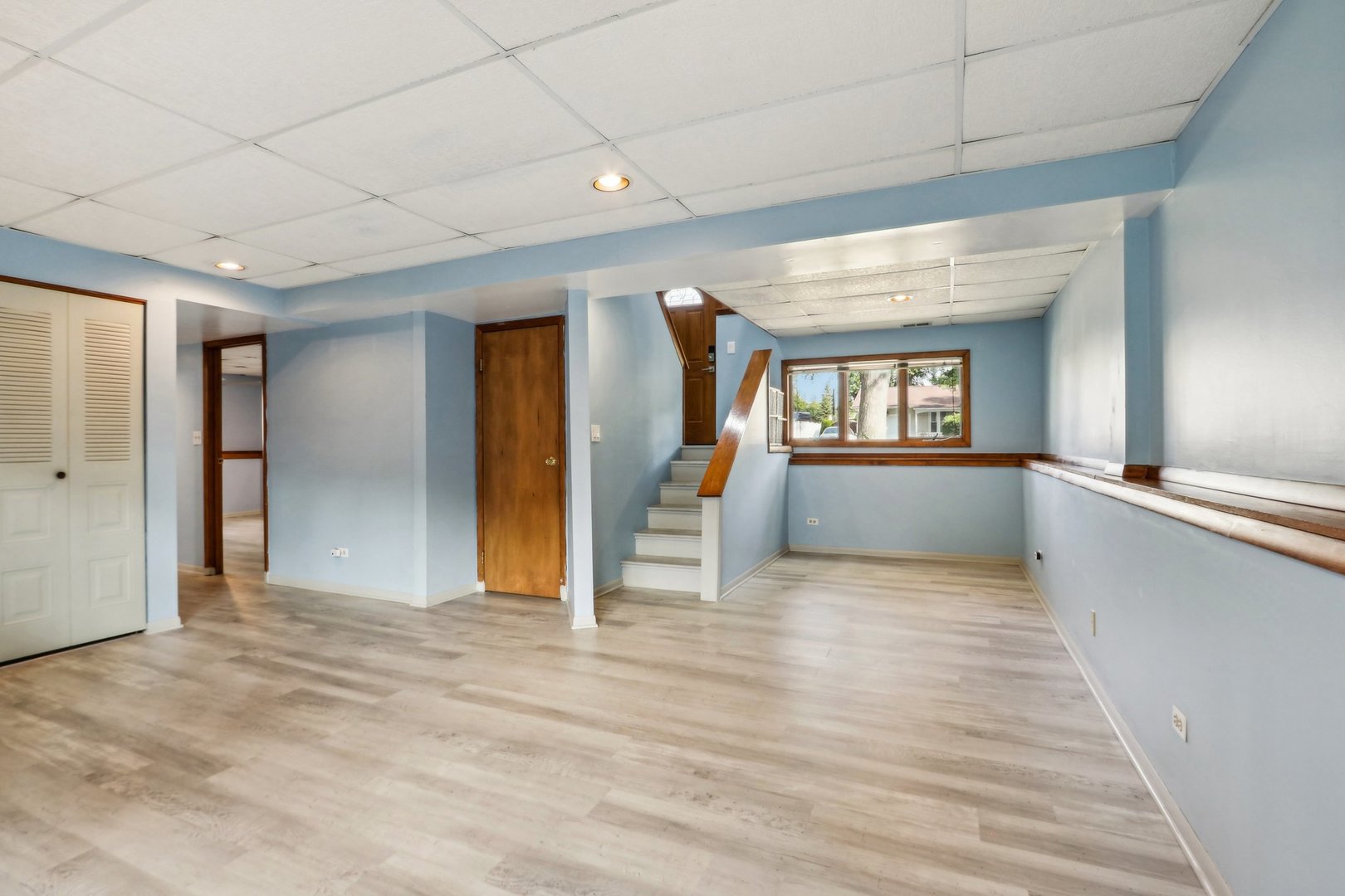 2405 Martin Lane Rolling Meadows, IL 60008 - Photo 14 of 22 a view of an empty room with wooden floor and a window