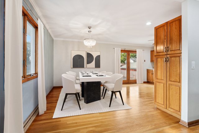 2405 Martin Lane Rolling Meadows, IL 60008 - Photo 4 of 22 a view of a dining room with furniture and wooden floor