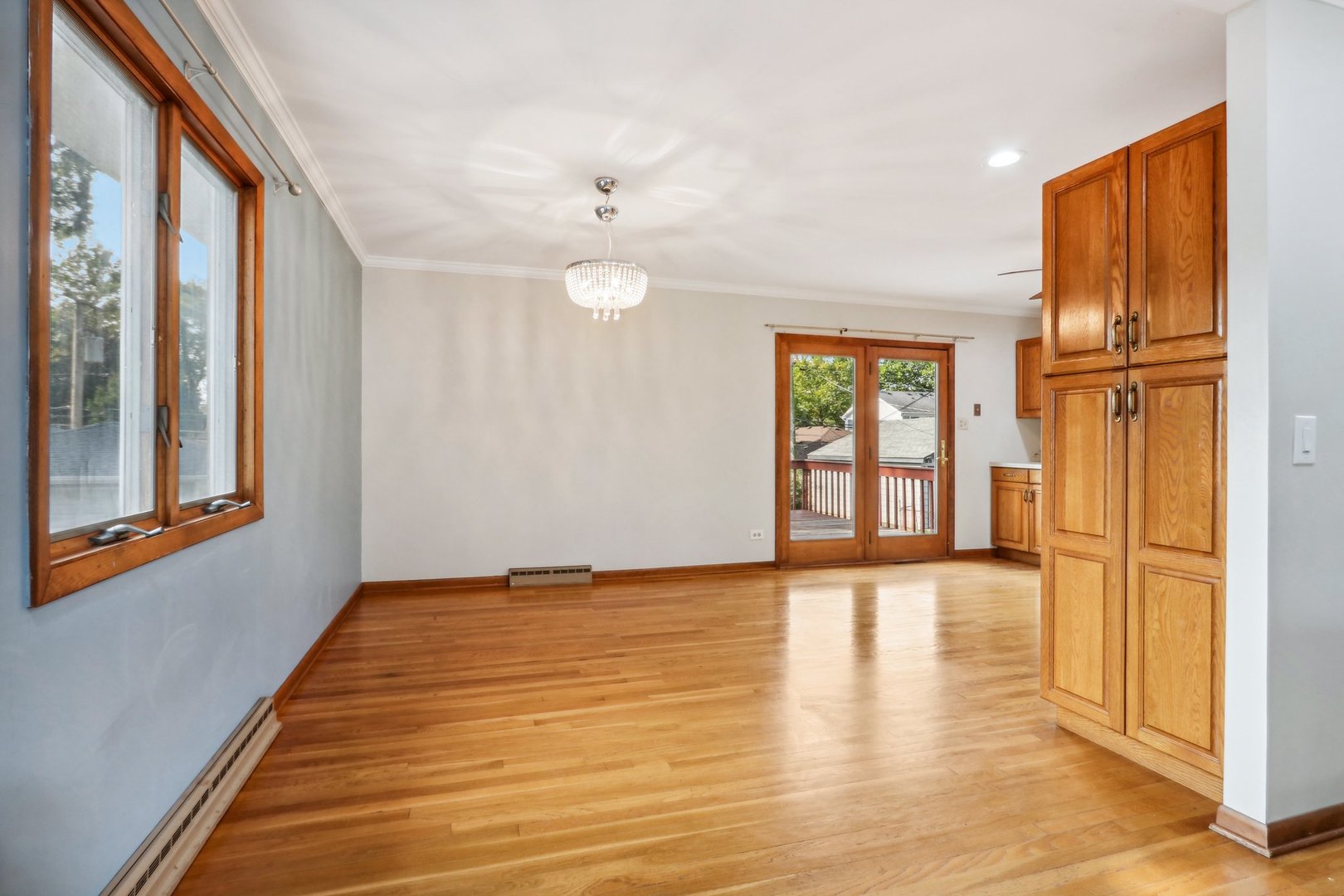 2405 Martin Lane Rolling Meadows, IL 60008 - Photo 5 of 22 a view of an empty room with a window and wooden floor