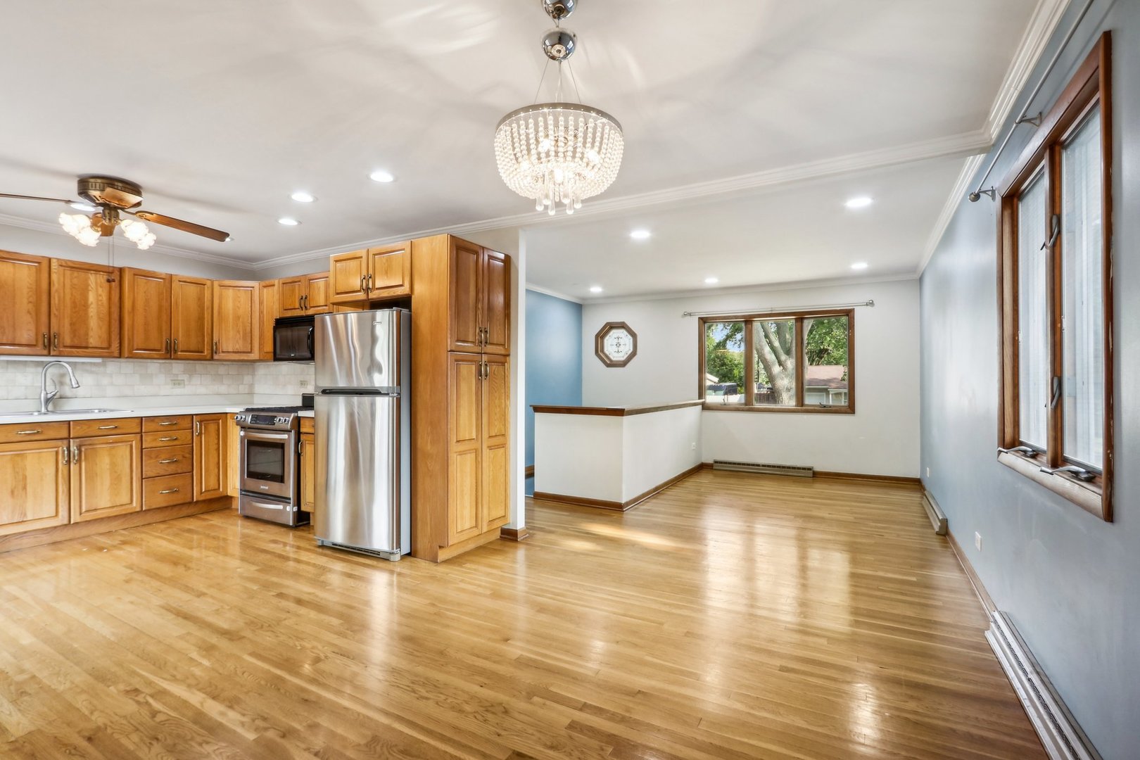 2405 Martin Lane Rolling Meadows, IL 60008 - Photo 6 of 22 a view of a kitchen with a refrigerator wooden floor and a window