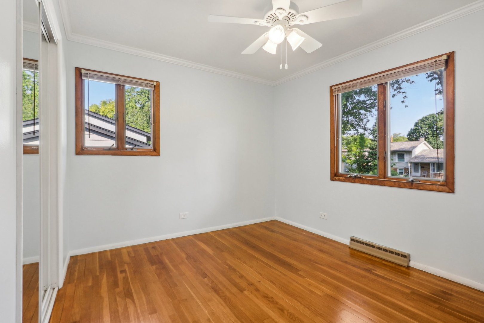 2405 Martin Lane Rolling Meadows, IL 60008 - Photo 10 of 22 a view of a bedroom with wooden floor and window