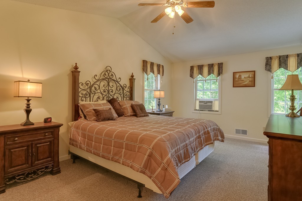 47 Babcock Tavern Road Ware, MA 01082 - Photo 12 of 27 a bedroom with a bed and a chandelier