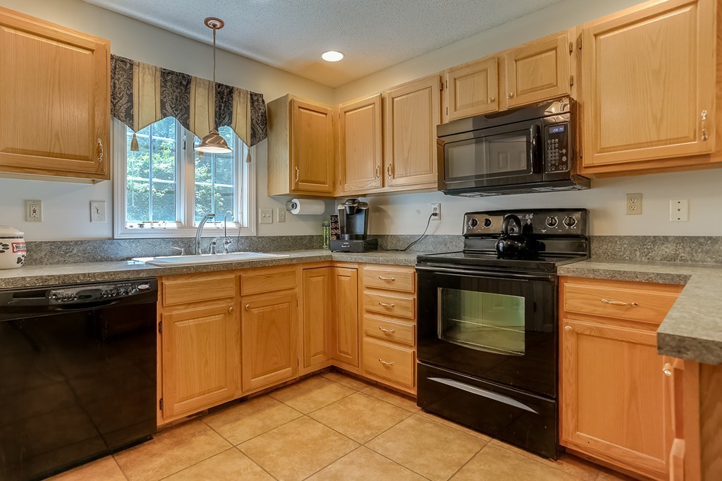 47 Babcock Tavern Road Ware, MA 01082 - Photo 4 of 27 a kitchen with stainless steel appliances granite countertop white cabinets granite counter tops and a window