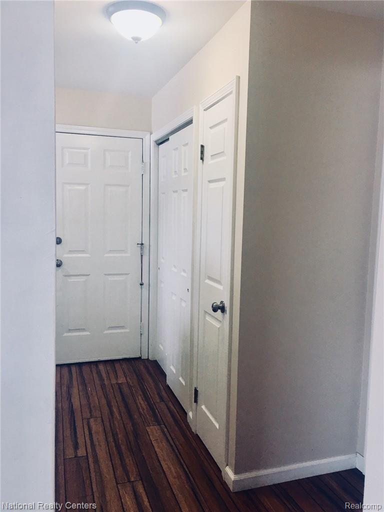 2922 North Lake George Road Dryden, MI 48428 - Photo 18 of 64 View down hall to 1st Fl Laundry, 2 MORE CLOSETS, LAV, & Garage Entry Door. And those FLOORS!