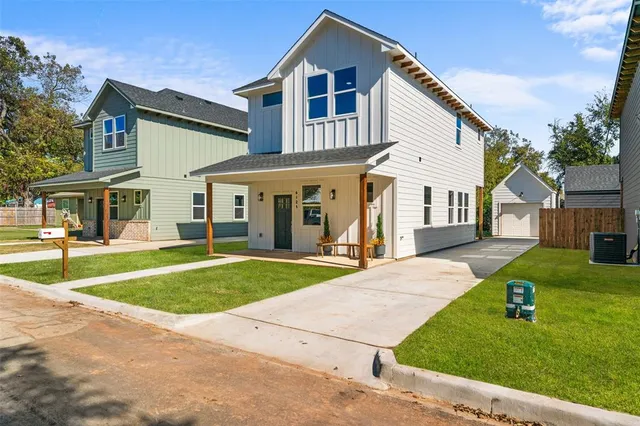 a front view of a house with a yard and porch
