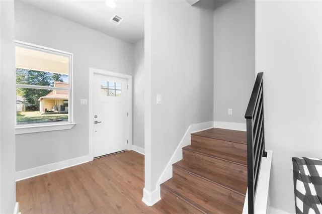 a view of entryway with wooden floor and window