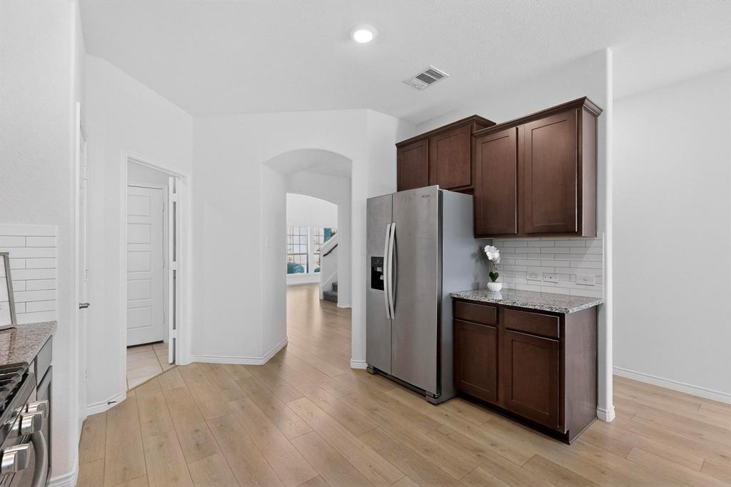 2917 Lampasas Lane Little Elm, TX 75068 - Photo 13 of 36 a kitchen with stainless steel appliances a refrigerator and a stove