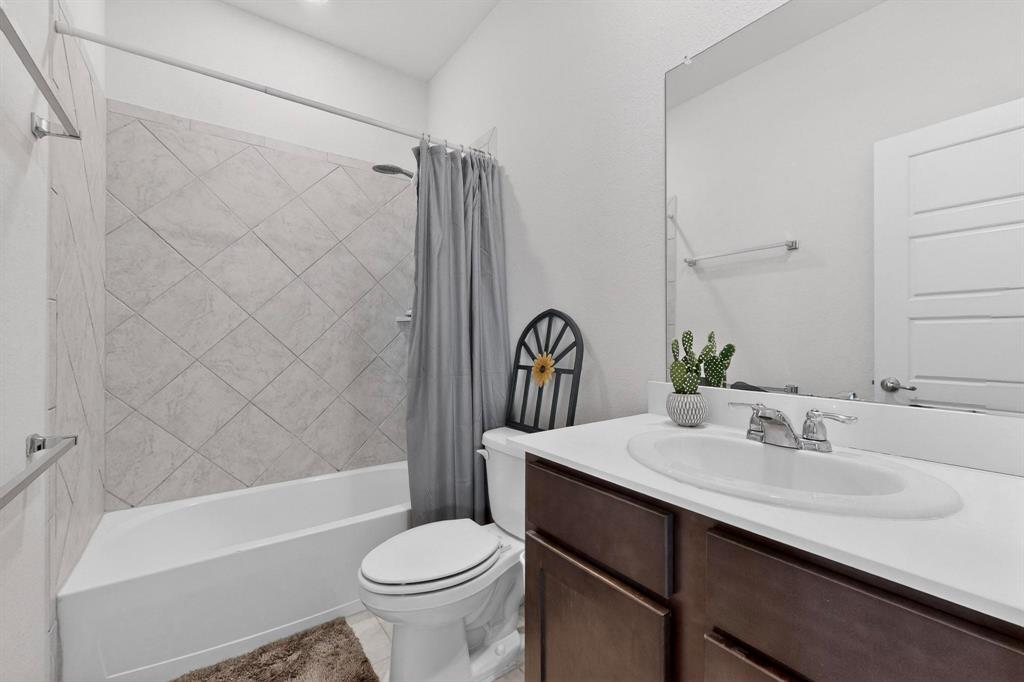 2917 Lampasas Lane Little Elm, TX 75068 - Photo 15 of 36 a bathroom with a sink a toilet and a bathtub