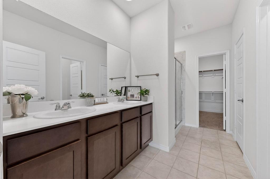 2917 Lampasas Lane Little Elm, TX 75068 - Photo 20 of 36 a bathroom with a sink and a mirror