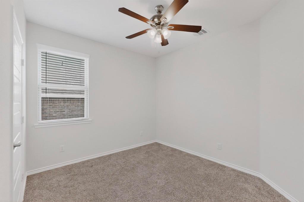 2917 Lampasas Lane Little Elm, TX 75068 - Photo 26 of 36 an empty room with a window and a fan