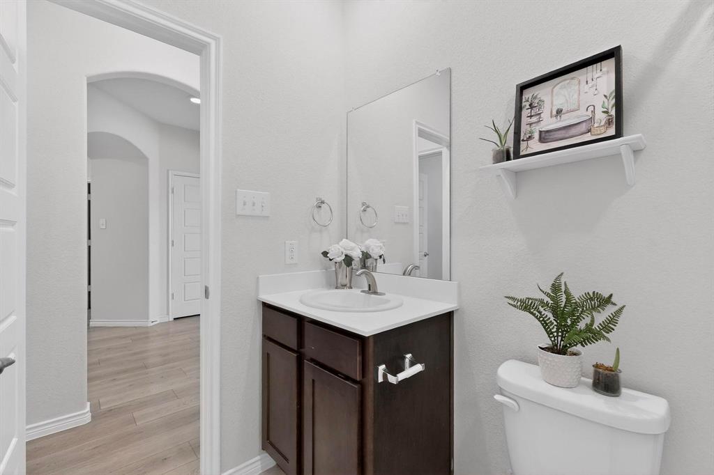 2917 Lampasas Lane Little Elm, TX 75068 - Photo 28 of 36 a bathroom with a sink a toilet and mirror