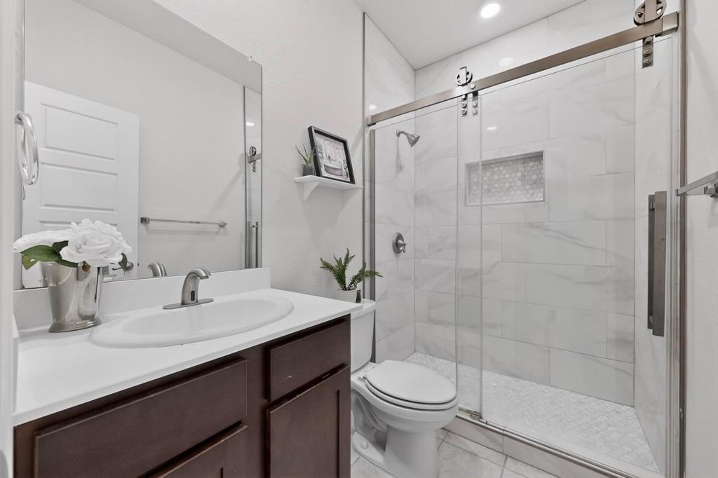 2917 Lampasas Lane Little Elm, TX 75068 - Photo 29 of 36 a bathroom with a sink a toilet and shower
