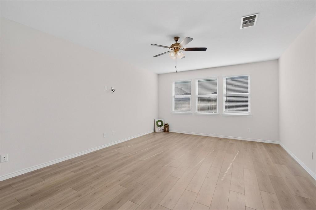 2917 Lampasas Lane Little Elm, TX 75068 - Photo 7 of 36 a view of empty room with wooden floor and fan